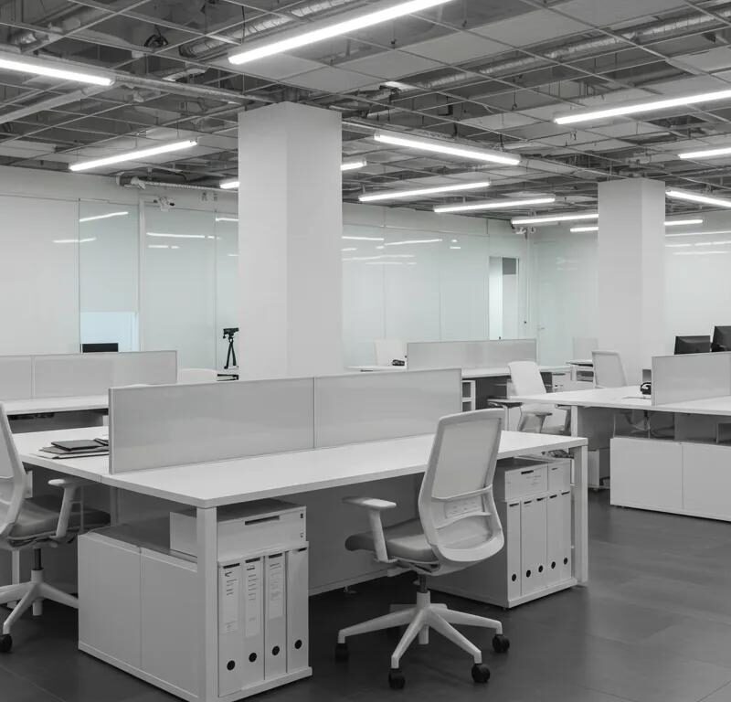 a sleek, modern office space gleams under bright, artificial lighting, showcasing pristine, freshly cleaned surfaces and organized workstations that highlight the transformative impact of professional commercial cleaning services.